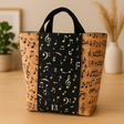 Tote bag with music note pattern on a wooden surface