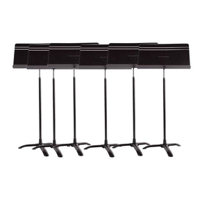 A set of six black Manhasset orchestral music stands with adjustable desks and a tripod base.
