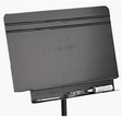 A black Manhasset music stand accessory shelf attached to a music stand, designed to provide storage for music paraphenalia.