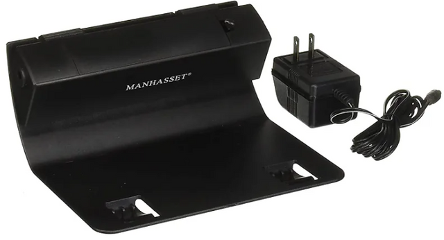 Manhasset Trente LED Music Stand Lamp, black in color, with an adjustable arm and a rectangular base, accompanied by a power plug.