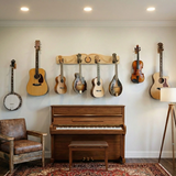 Music-themed room with guitars, banjo, and piano against a wall.