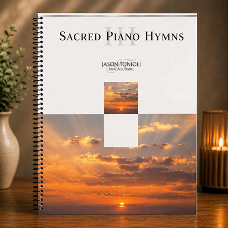 Music book titled 'Sacred Piano Hymns III' by Jason Tonioli with sunset design on cover, placed on a wooden surface.