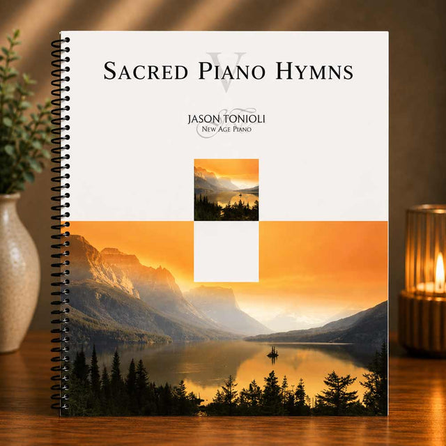Book titled 'Sacred Piano Hymns' by Jason Tonoli with mountain and lake cover design on a wooden surface.