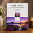 Piano music book titled 'Sacred Hymns VI' by Jason Toniooli on a wooden surface with a scenic cover.