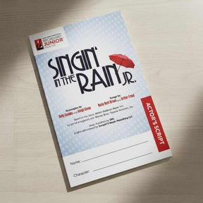 Actor's script for 'Singin' in the Rain Jr.' on a wooden surface