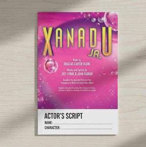 Xanadu Jr. actor's script cover with pink and purple design on a wooden surface